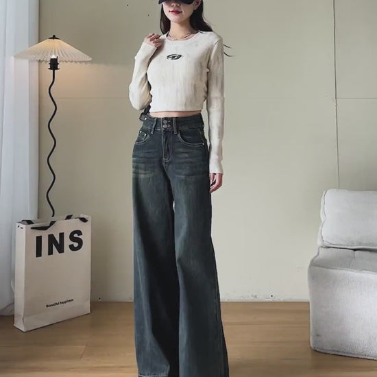 YEEYEEWang Wide-Leg jeans video Fleece-Lined in Mid-Wash Blue: Asian model walks showing drapey fit, zooms to high waist and cuffed hem, lifts leg to reveal thick fleece lining, stroking it.
