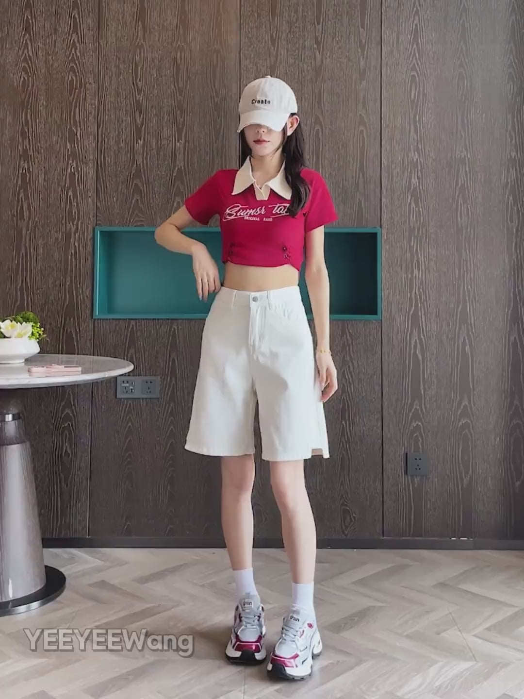 YEEYEEWang Denim Bermuda Shorts video in White: Asian model strides, poses and spins to display high-waist double-button fit, side-slit hems, daisy-embroidered back pockets in a modern room.